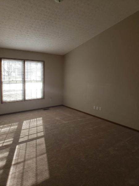an empty living room with a window