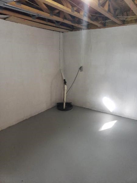 a white room with a pipe in the corner