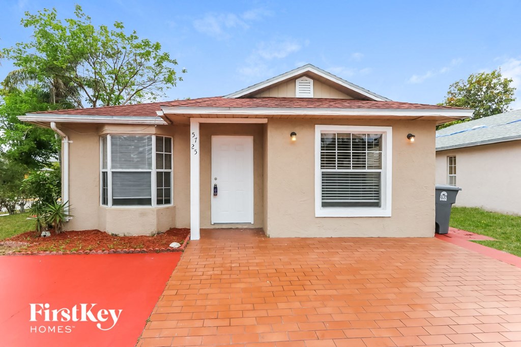 a house with a driveway and a white door