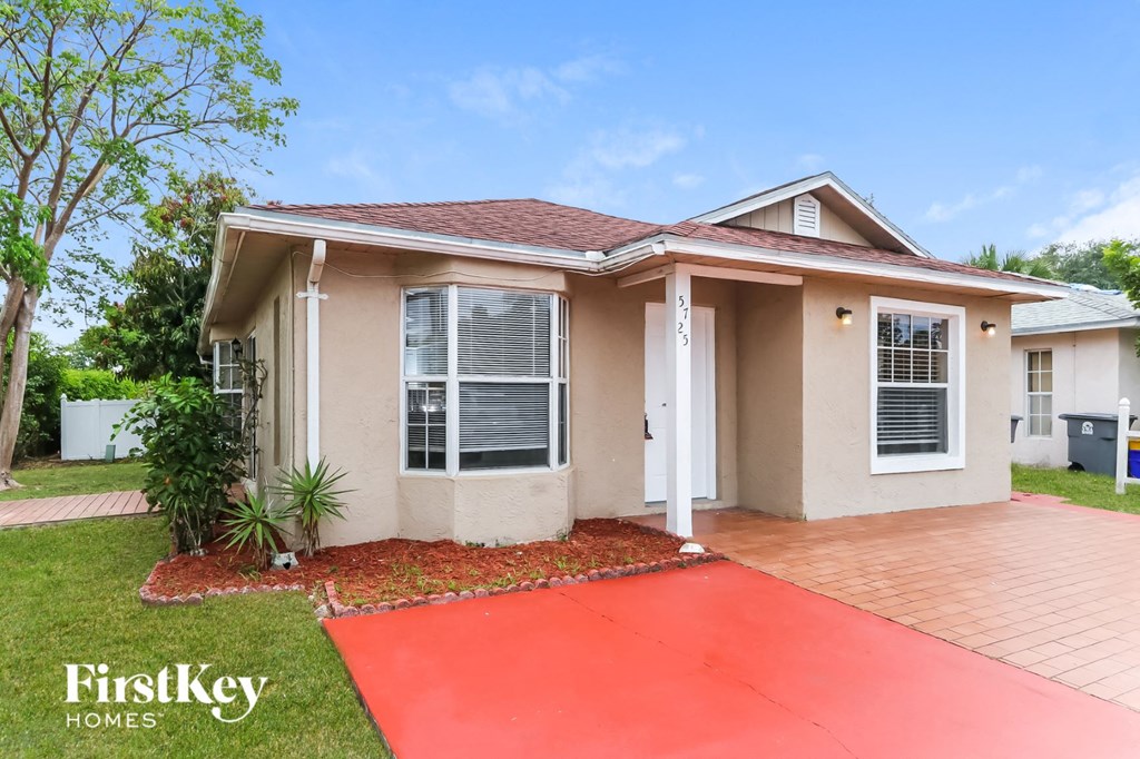 a house with a red driveway in front of it