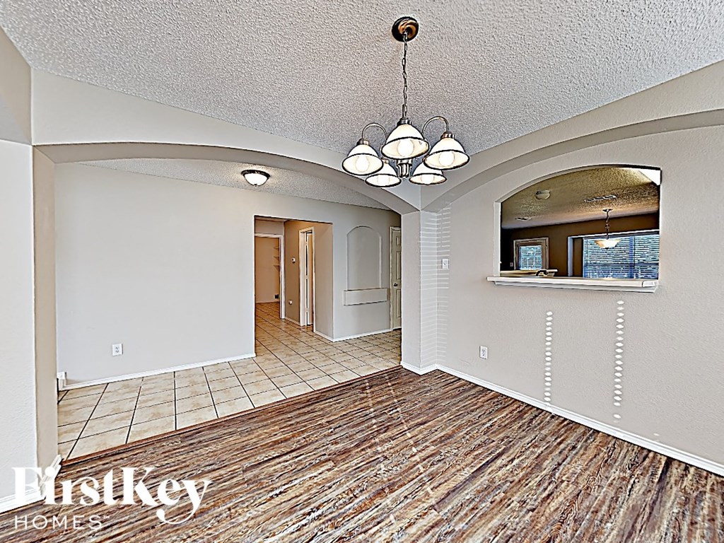a living room and dining room with a wood floor