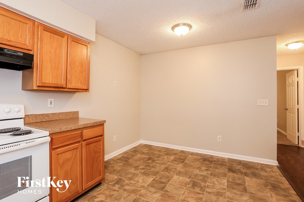 a kitchen with wood cabinets and a stove top oven