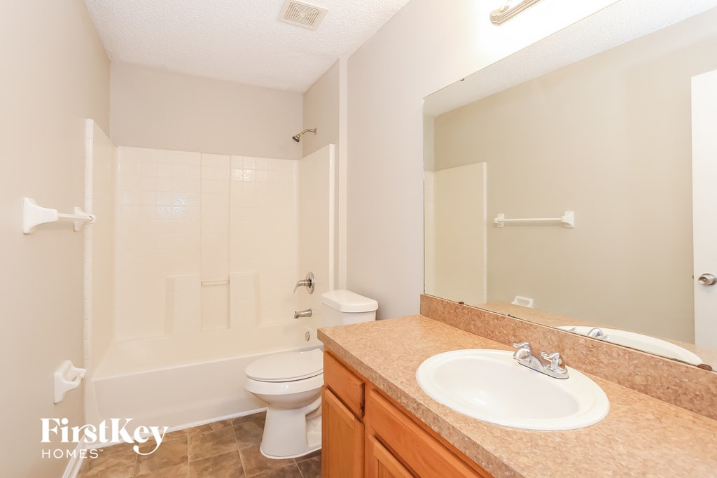 a bathroom with a sink toilet and a shower