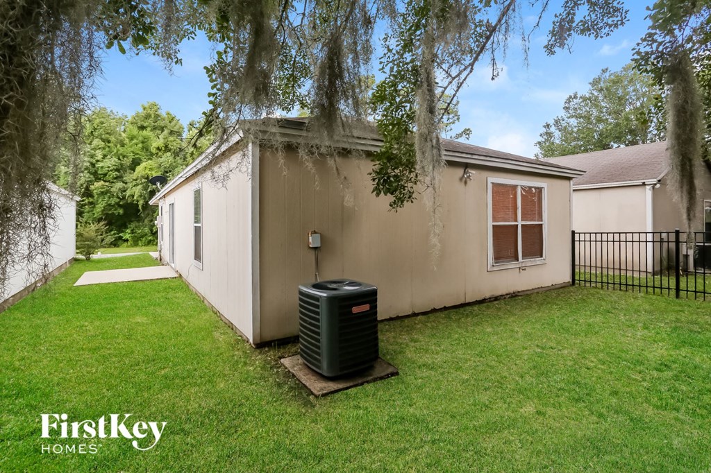 a backyard with a house and a heater in the grass