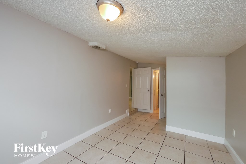 A room with a white ceiling and a white door.