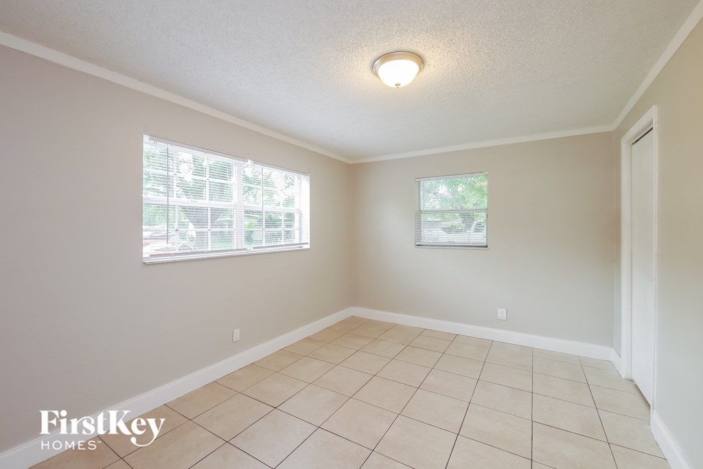 A room with a FirstKey Homes logo on the bottom left corner.