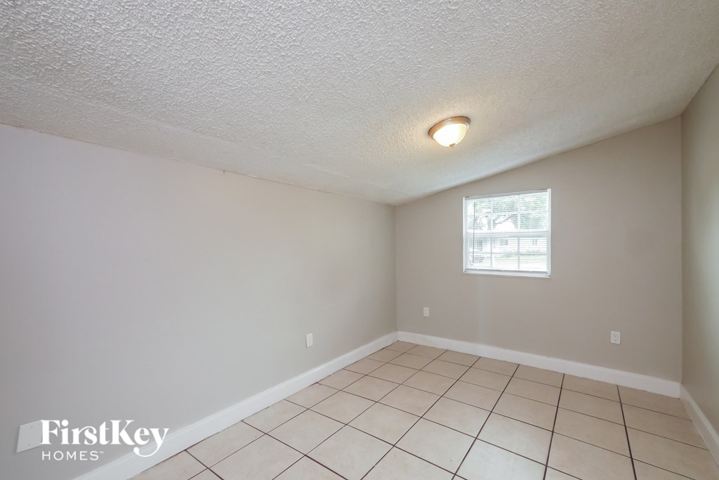 A room with a FirstKey Homes logo on the bottom left.