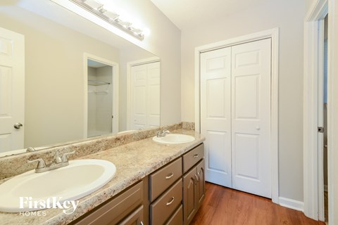 a bathroom with two sinks and a large mirror
