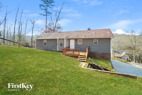 a house on a hill with a deck and a pool