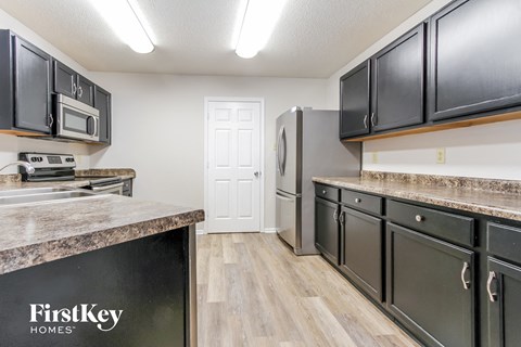a kitchen with stainless steel appliances and granite counter tops
