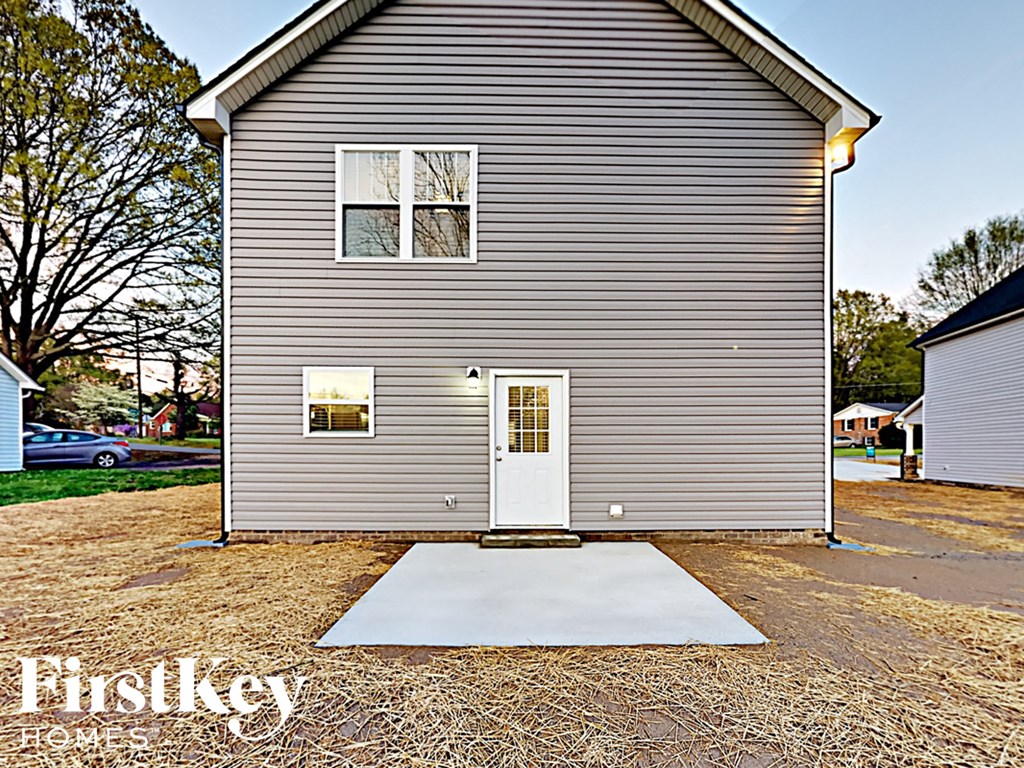 A grey house with a white door and windows.
