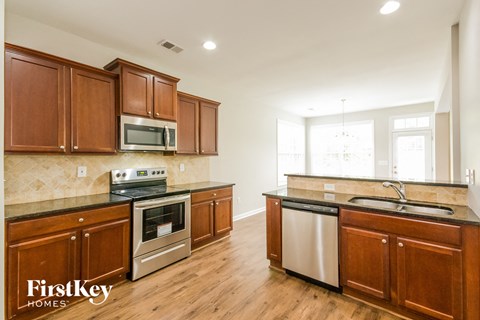 a kitchen with wooden cabinets and stainless steel appliances