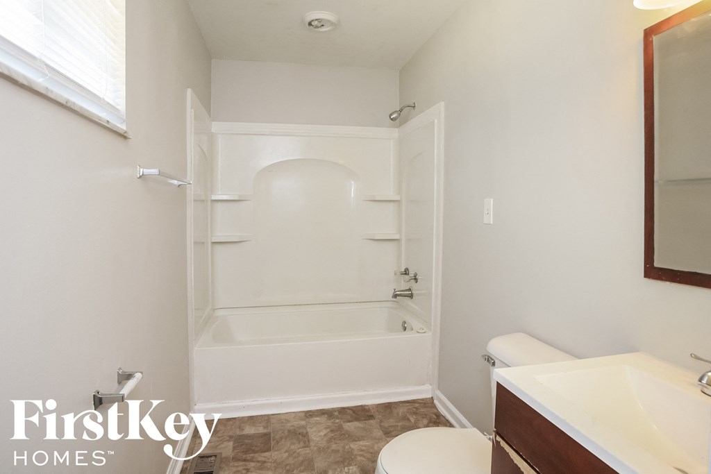 a small bathroom with a toilet and a tub and a sink