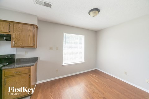A kitchen with wooden cabinets and a window.