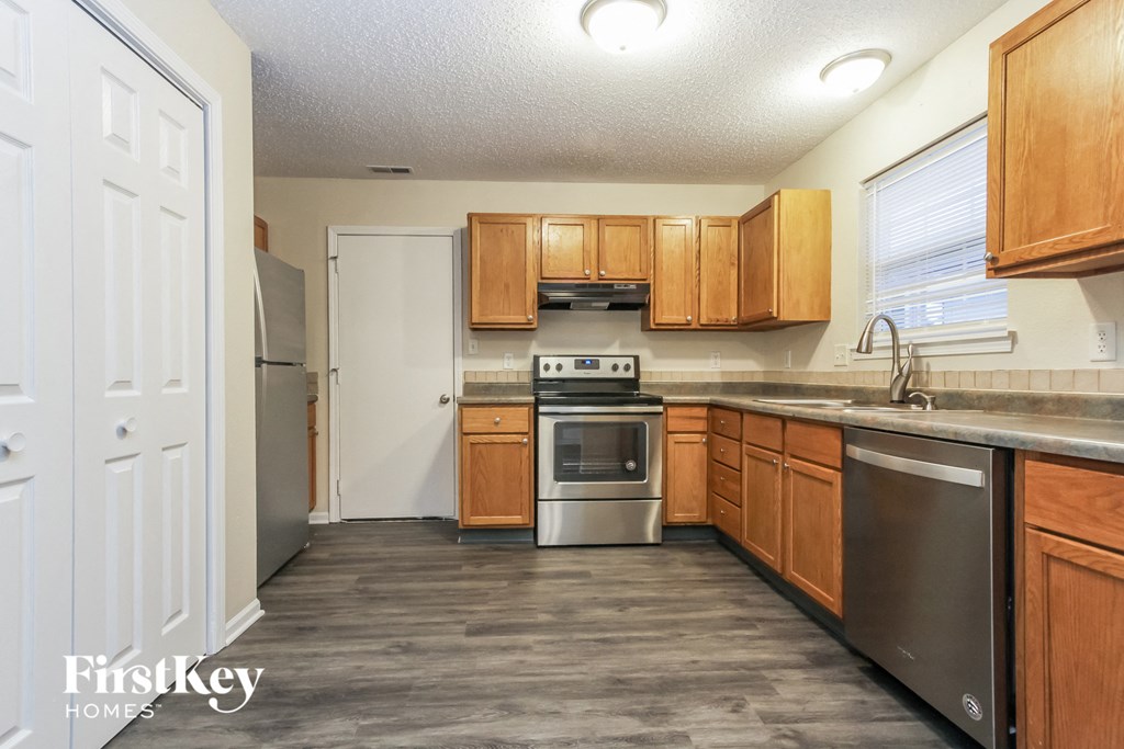 A kitchen with wooden cabinets and stainless steel appliances.