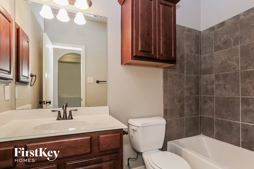 a bathroom with a sink toilet and a bath tub