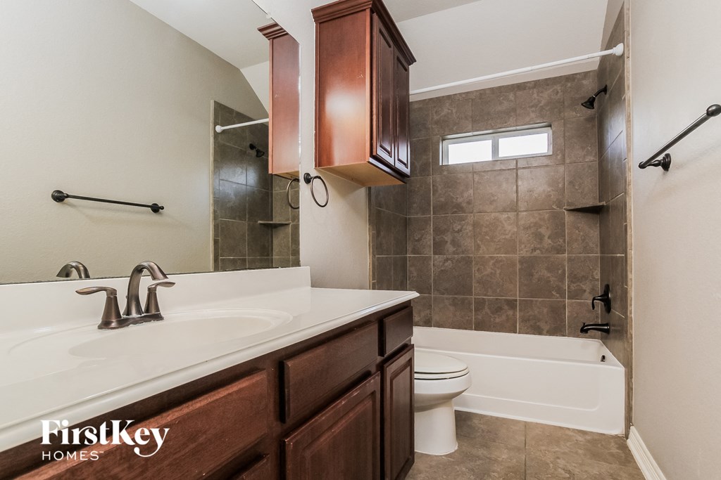 a bathroom with a sink and a toilet and a tub
