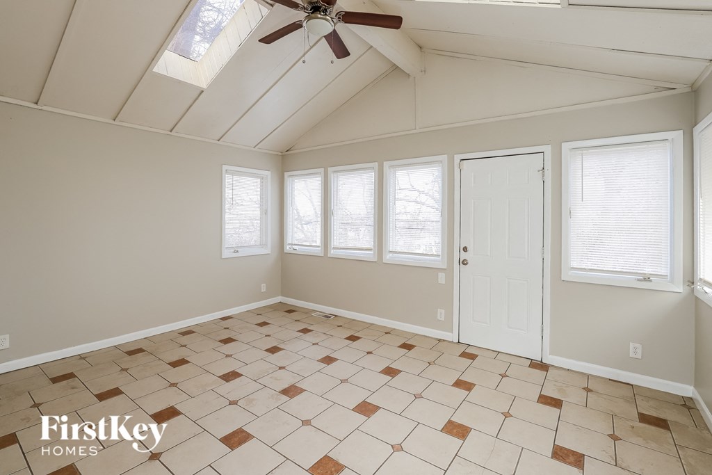 A room with a tiled floor and a ceiling fan.