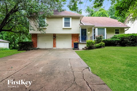 a house with a cracked driveway in front of it