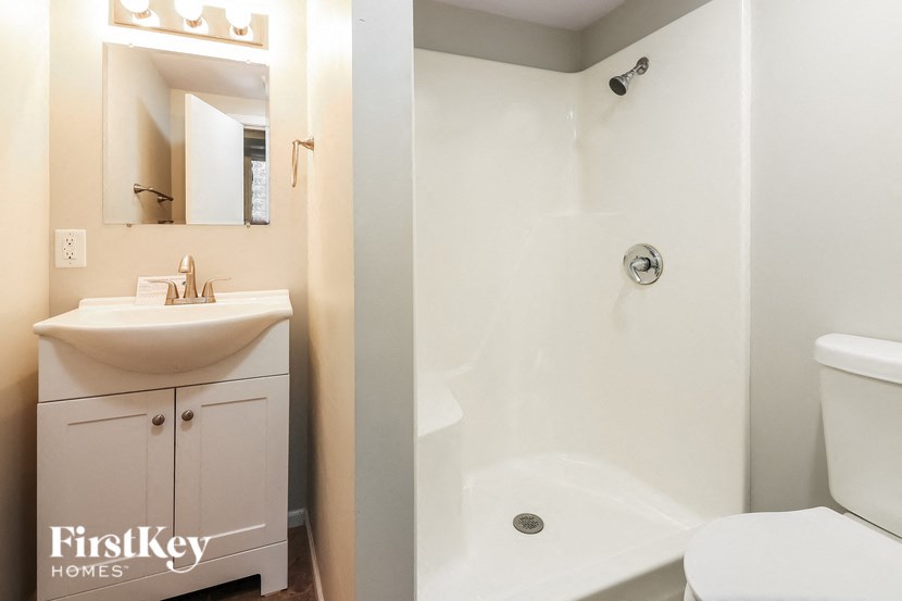 a bathroom with a toilet sink and a shower