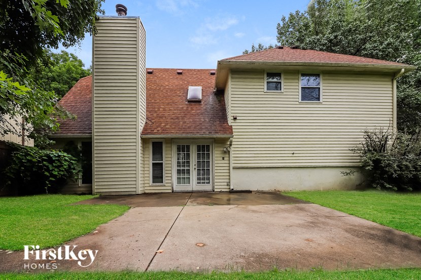 a white house with a driveway and a garage door