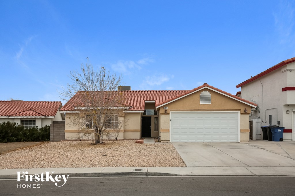 A house with a brown roof and a white garage door is for sale.