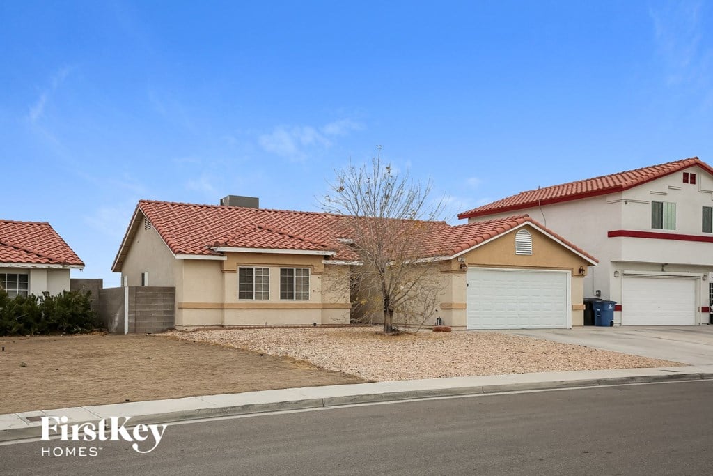 A house with a red tile roof is for sale by Firstkey Homes.