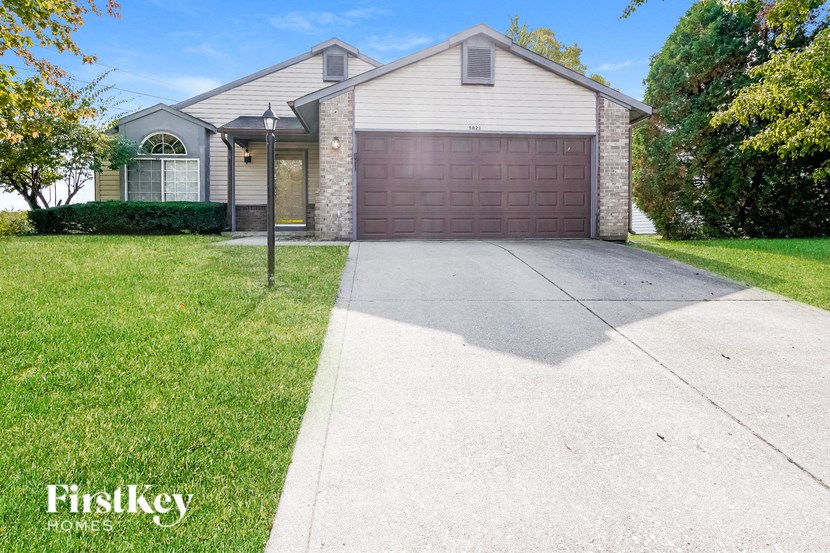 a white house with a driveway and a garage door