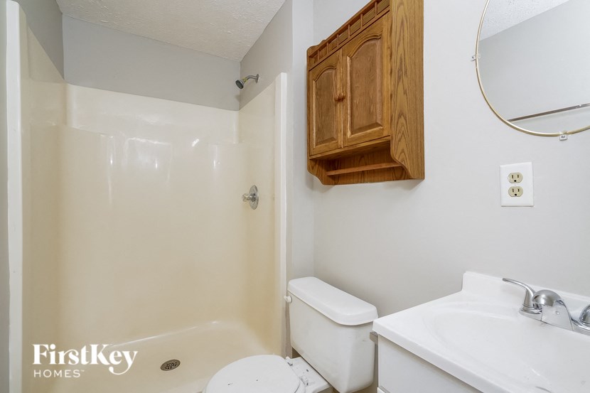 a bathroom with a sink toilet and a shower