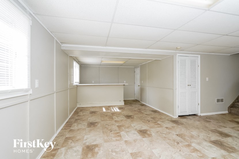 an empty room with white walls and a tile floor