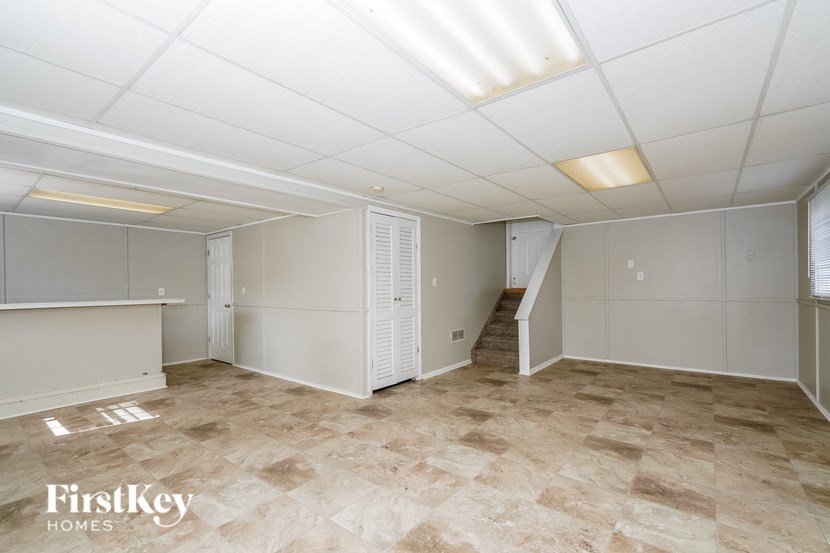 an empty room with white walls and a tile floor