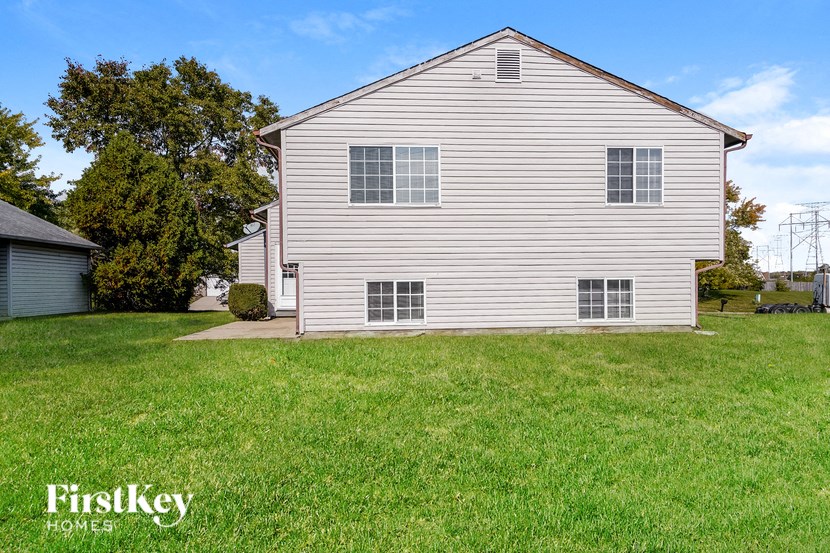 a white house with a lawn in front of it