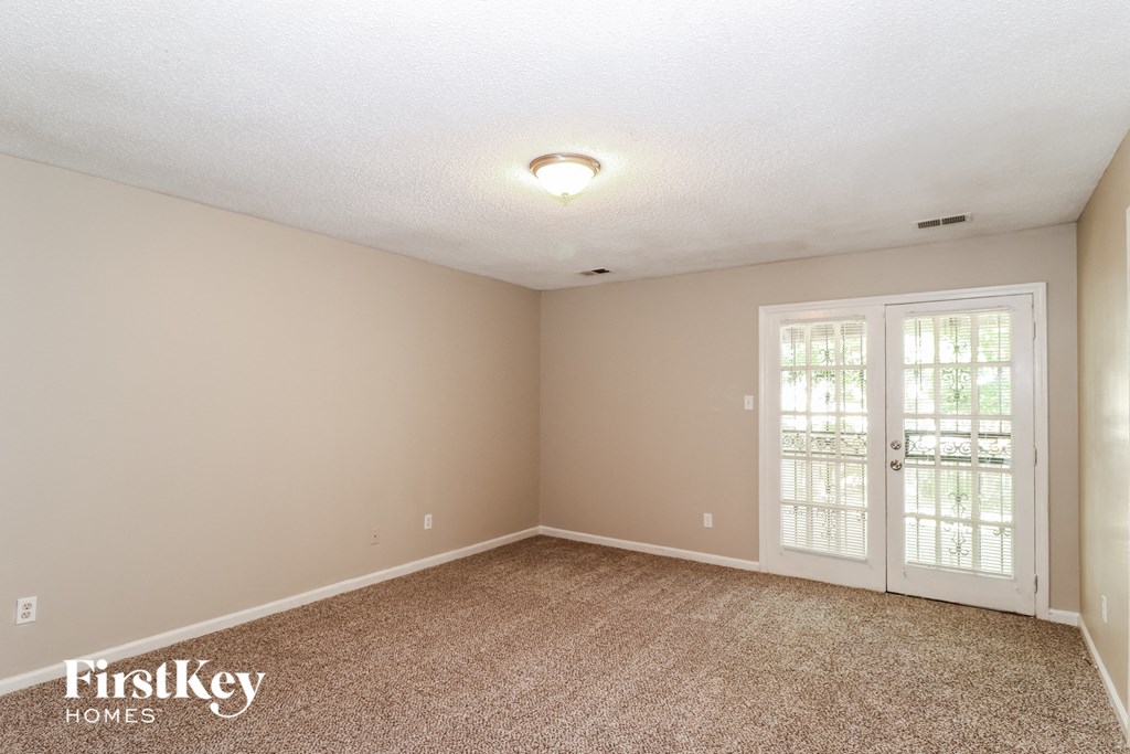 the spacious living room for sale has a carpeted floor