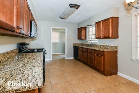 a kitchen with wooden cabinets and granite counter tops