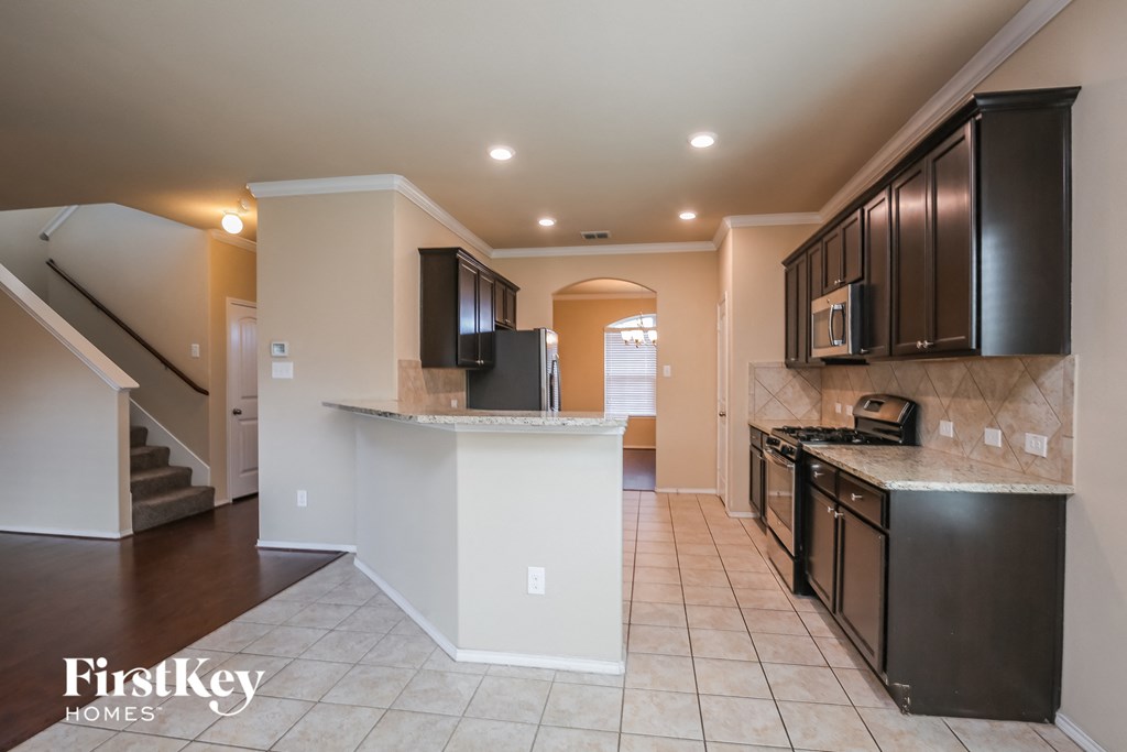 a kitchen with black cabinets and a white counter top