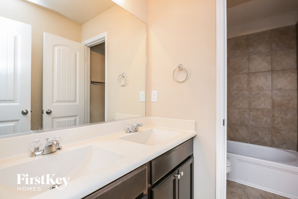 a bathroom with two sinks and a large mirror