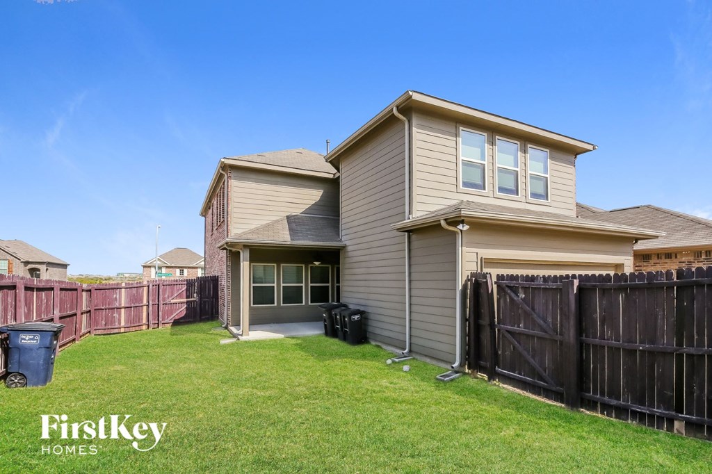 a house with a yard and a fence