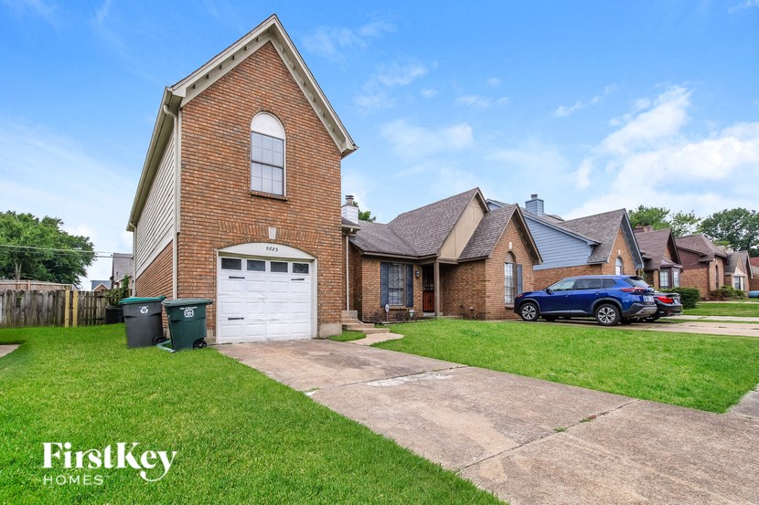 a house with a garage and a car parked in the driveway
