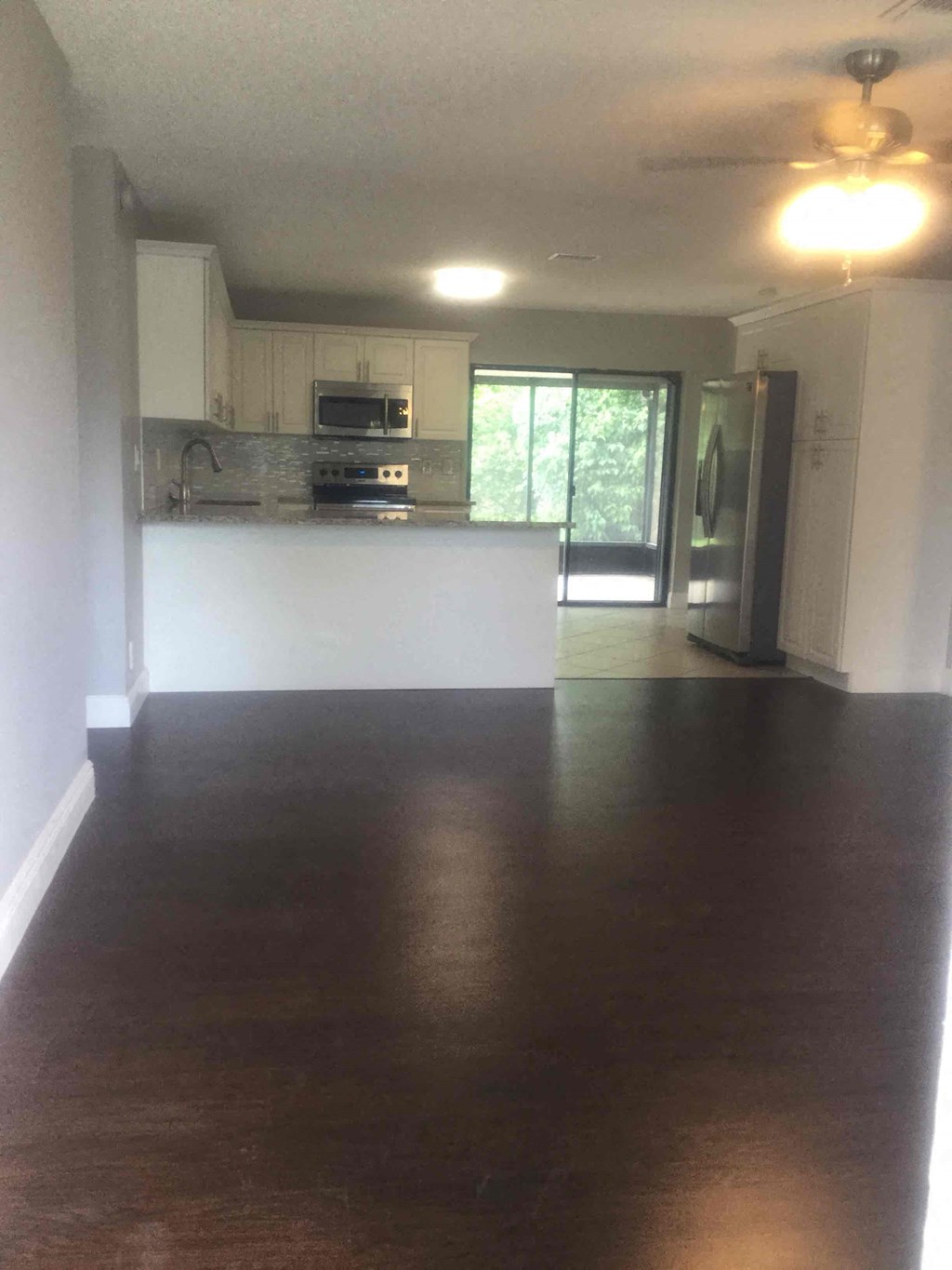 A kitchen with a stove top oven and a microwave.