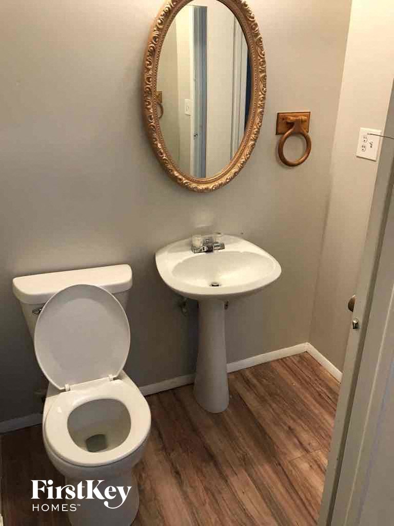 a small bathroom with a toilet sink and mirror