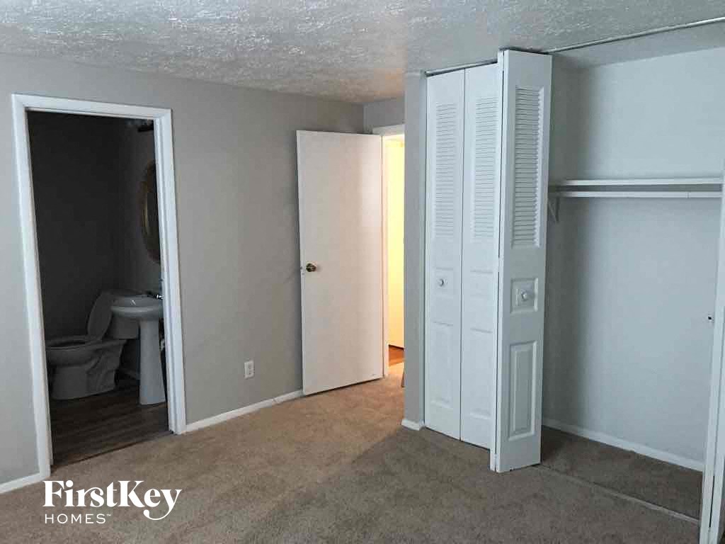 an empty room with a closet and a toilet in it