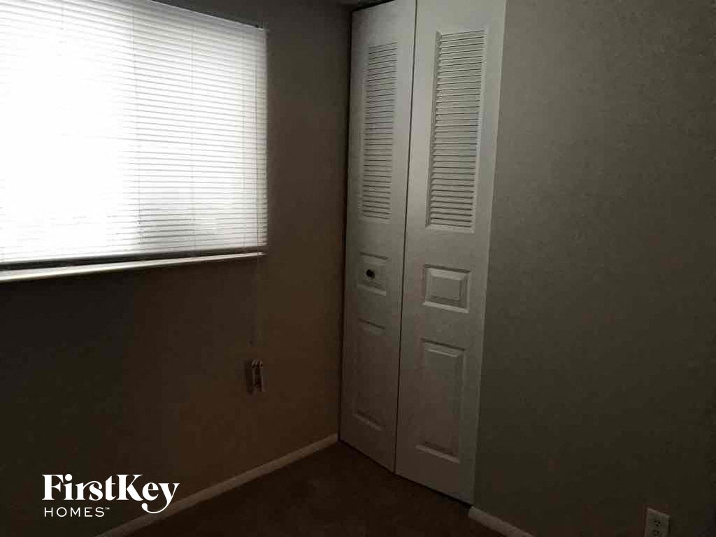 a room with a door and a window and a closet