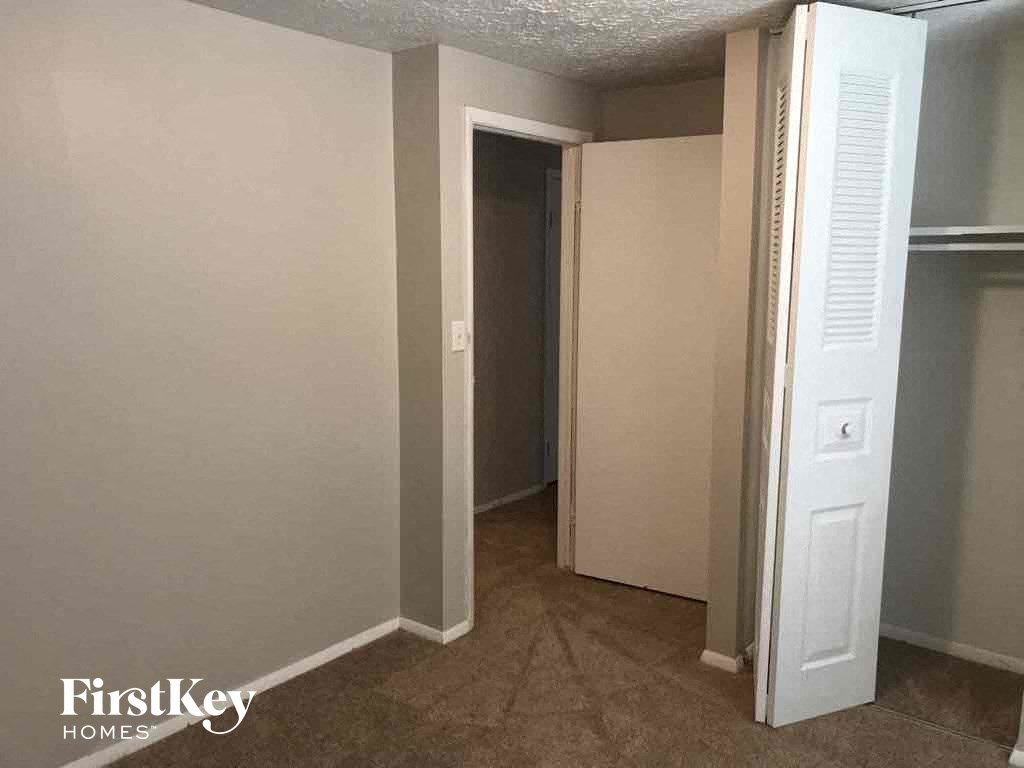 a room with a closet and a door to a closet