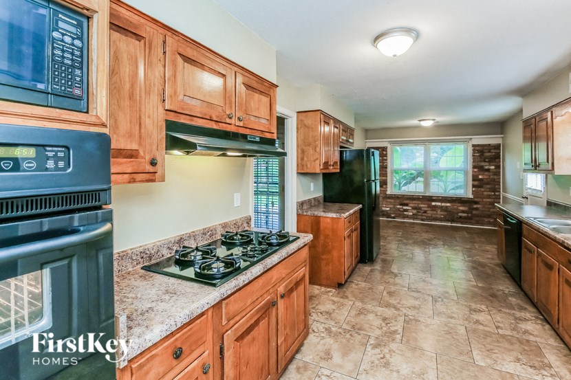 a kitchen with wood cabinets and black appliances