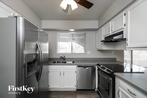 a kitchen with stainless steel appliances and white cabinets