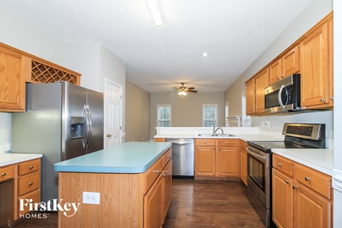 A kitchen with wooden cabinets and a blue countertop.