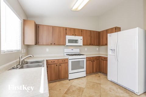 a kitchen with white appliances and wooden cabinets