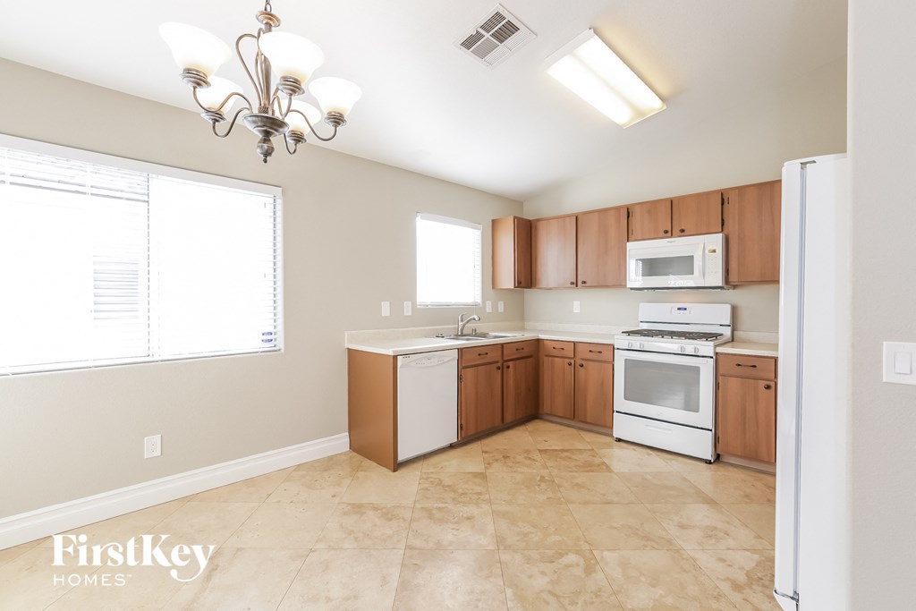 a kitchen with wooden cabinets and white appliances