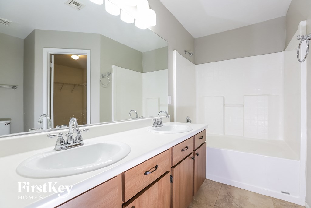 a bathroom with two sinks and a large mirror