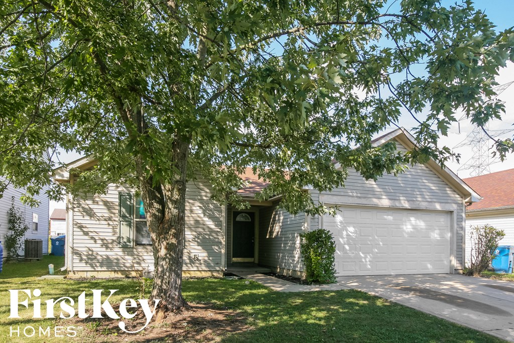 a white house with a tree in front of it